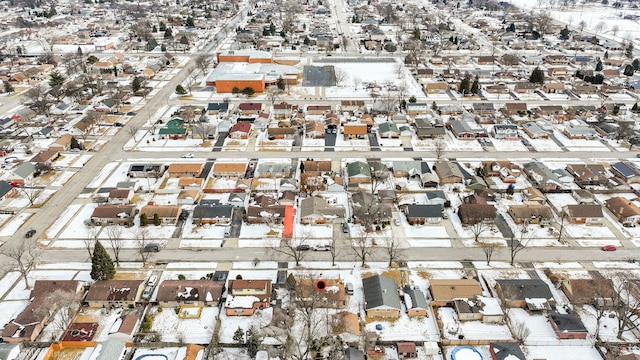 snowy aerial view featuring a residential view