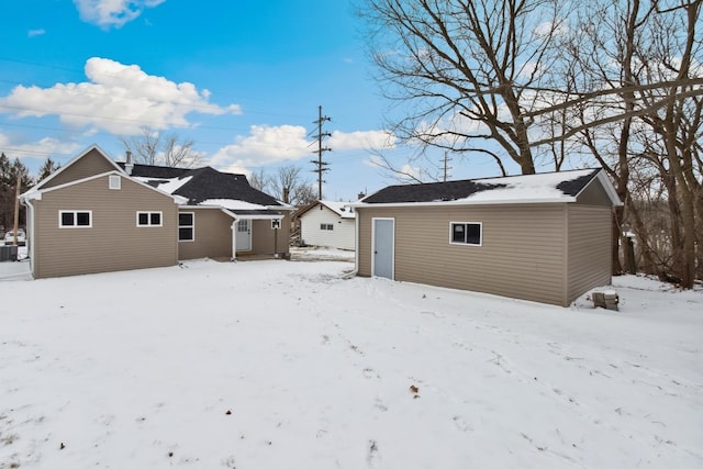 snow covered property featuring central AC