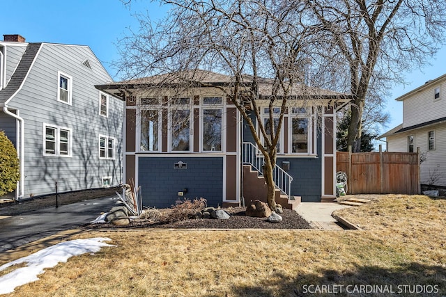 view of front of home featuring entry steps and fence