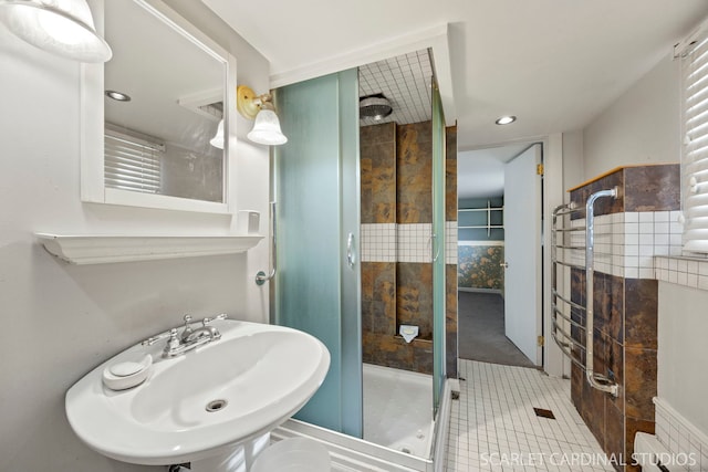 full bath with a stall shower, recessed lighting, a sink, and tile patterned floors