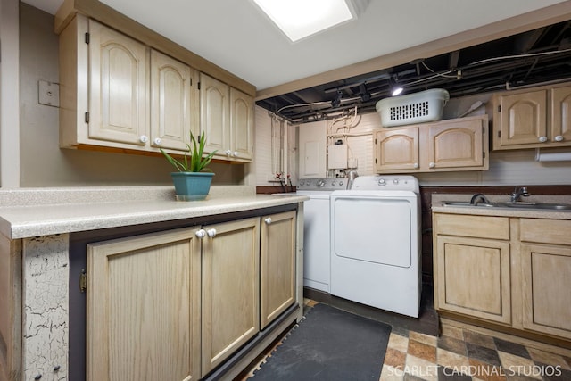 laundry area with washer and dryer, cabinet space, and a sink