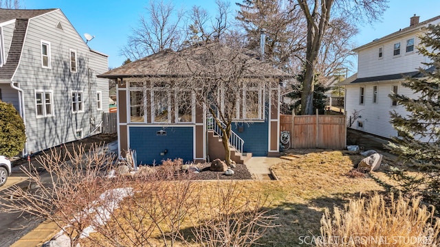 view of front of home featuring fence