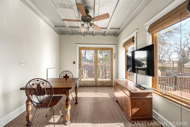 dining space with ceiling fan, baseboards, and wood finished floors