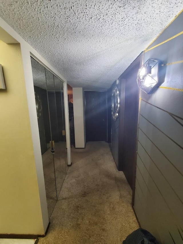 corridor with carpet flooring and a textured ceiling