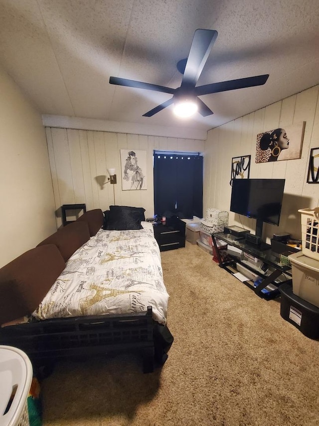 bedroom with ceiling fan, carpet floors, and a textured ceiling