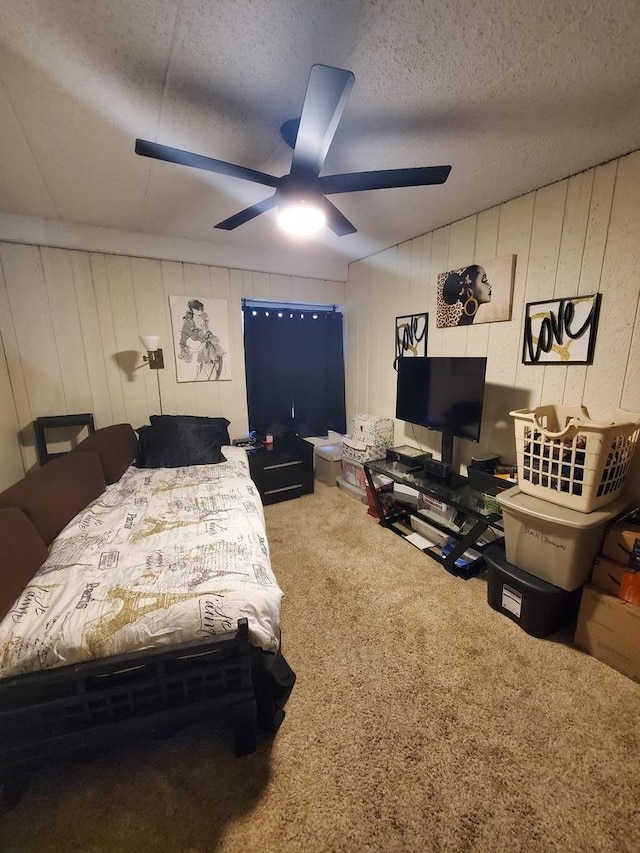 bedroom featuring ceiling fan, carpet flooring, and a textured ceiling