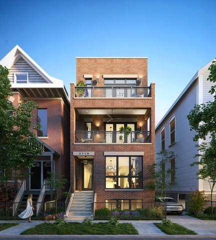 view of front of house with brick siding, stairway, and a balcony