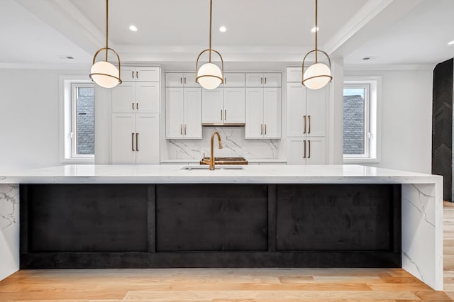 kitchen with hanging light fixtures and a large island with sink