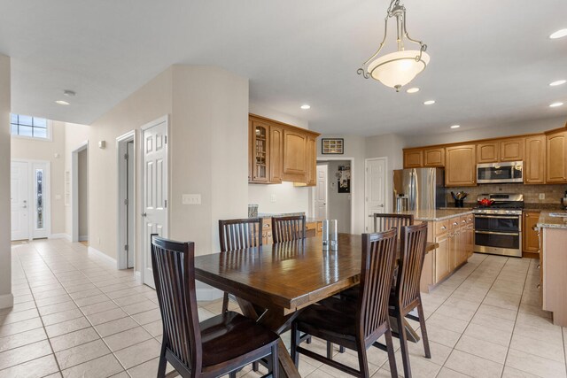 dining room with recessed lighting, baseboards, and light tile patterned flooring