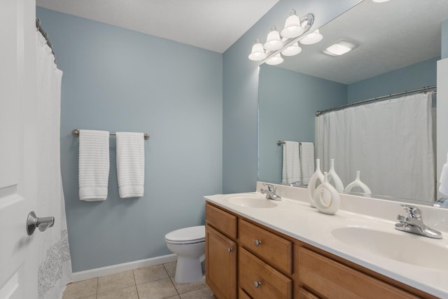 full bath with double vanity, tile patterned flooring, a sink, and toilet