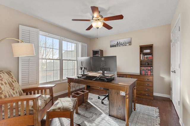 home office featuring dark wood-style flooring, ceiling fan, and baseboards