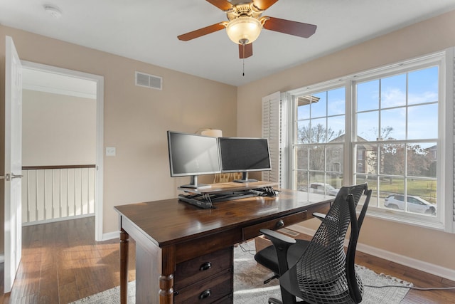 home office with a wealth of natural light, wood finished floors, and visible vents