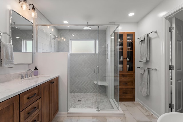 bathroom with a stall shower, baseboards, marble finish floor, vanity, and recessed lighting