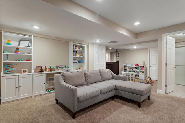 living room with recessed lighting, visible vents, and light colored carpet