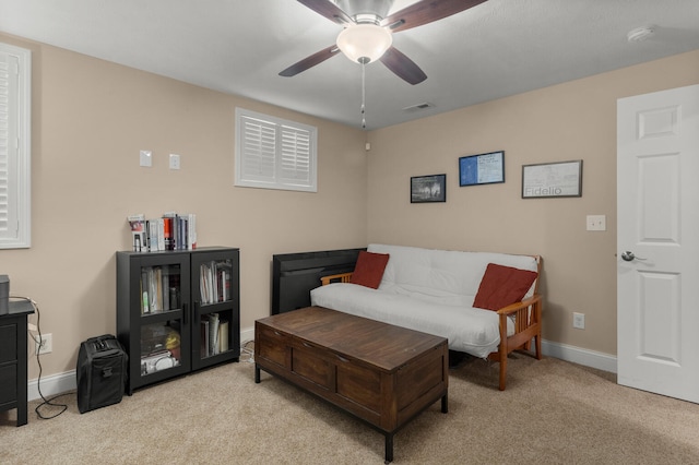 carpeted living room with visible vents, ceiling fan, and baseboards