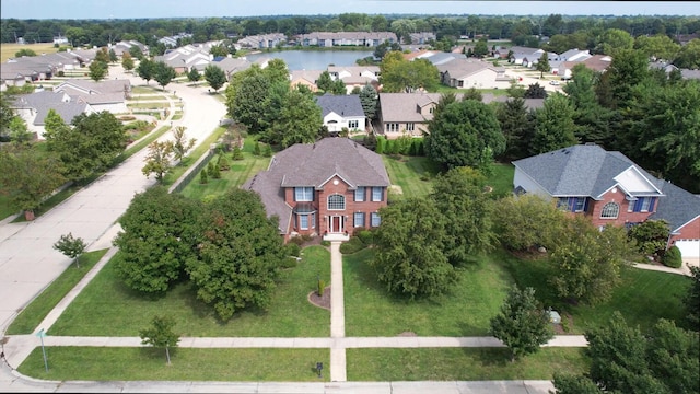 birds eye view of property with a residential view and a water view