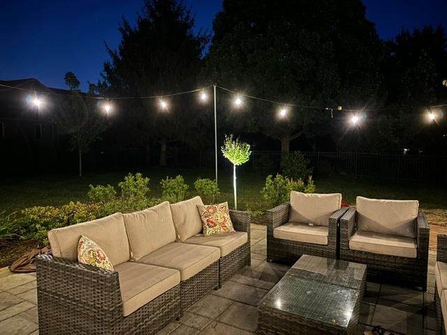 patio at twilight with fence and an outdoor hangout area