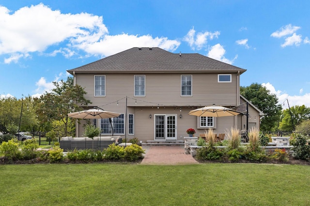 back of property with fence, outdoor lounge area, a lawn, and a patio