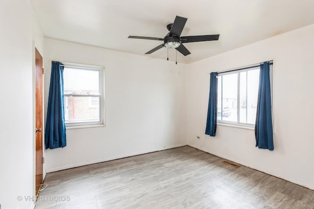 empty room featuring light hardwood / wood-style flooring and ceiling fan