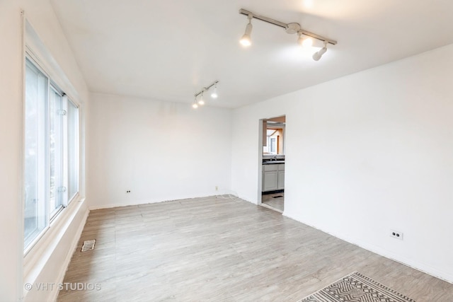 unfurnished room with light hardwood / wood-style flooring