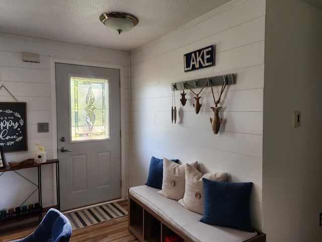 mudroom featuring hardwood / wood-style flooring and a textured ceiling