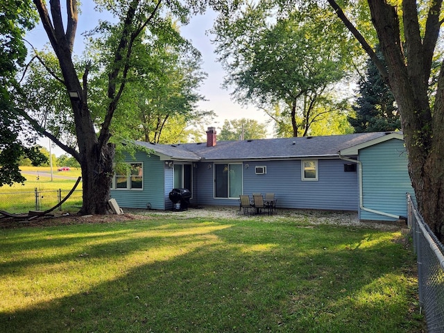 rear view of house featuring a lawn