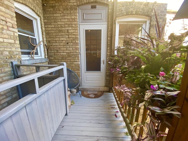 entrance to property featuring brick siding