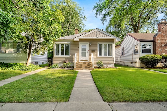 bungalow-style home featuring a front yard