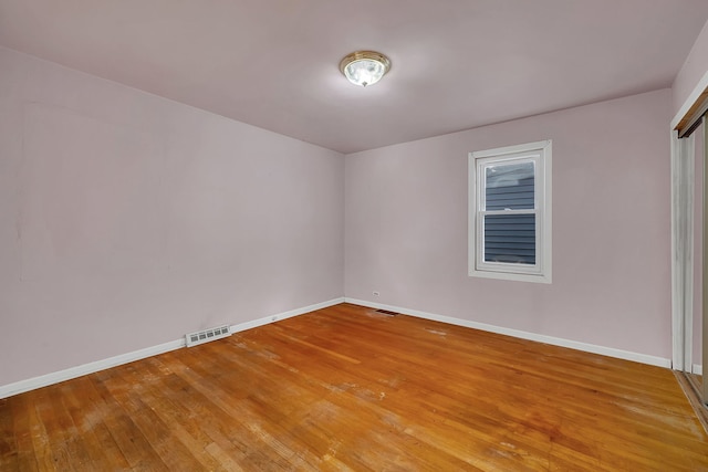 spare room with hardwood / wood-style flooring