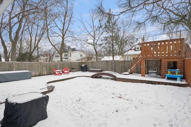 yard covered in snow with a playground