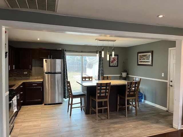 dining area featuring baseboards, visible vents, light wood-style floors, beam ceiling, and recessed lighting