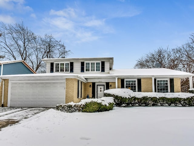 traditional home featuring brick siding and an attached garage