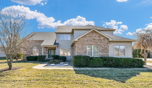 traditional-style house with a front yard and brick siding