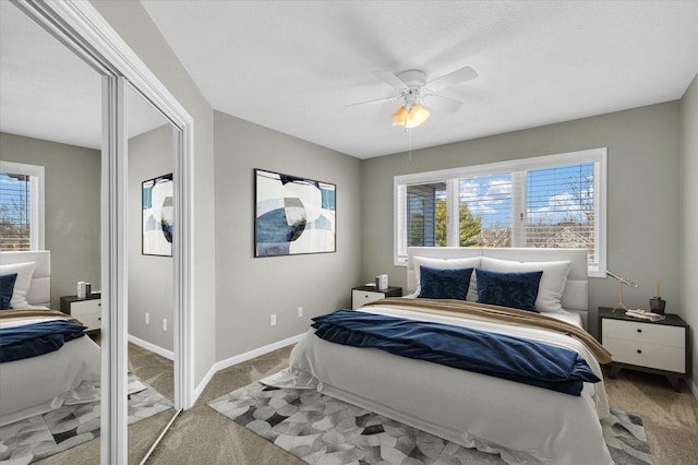 bedroom featuring light carpet, multiple windows, and baseboards