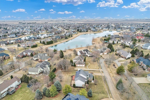 drone / aerial view featuring a residential view and a water view