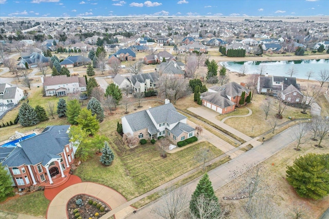 birds eye view of property with a water view and a residential view