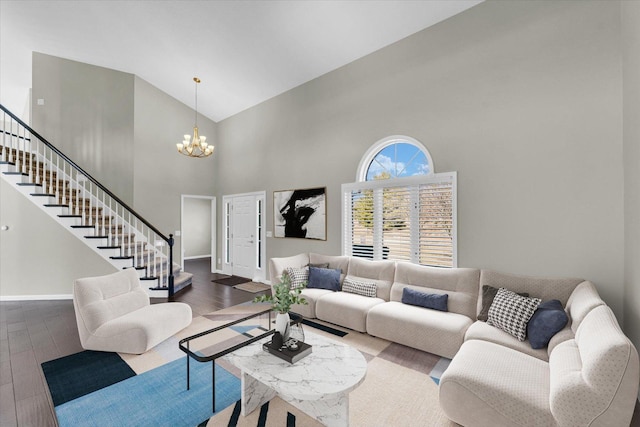 living area featuring a notable chandelier, stairs, baseboards, and dark wood-style flooring