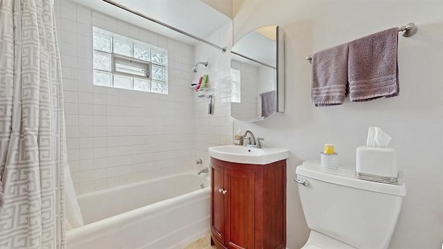 bathroom with toilet, shower / bathtub combination with curtain, and vanity