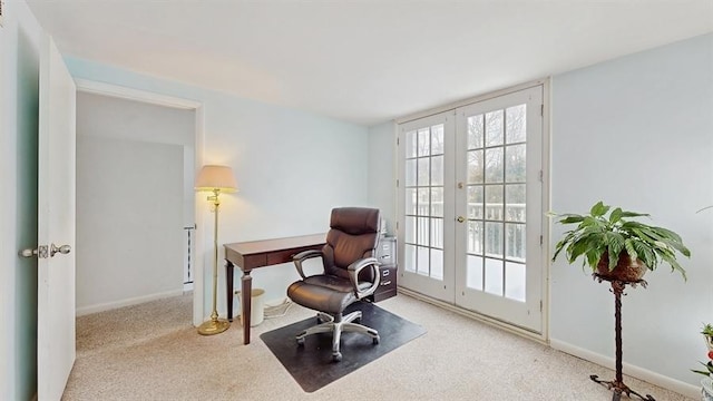 office with french doors, light colored carpet, and baseboards