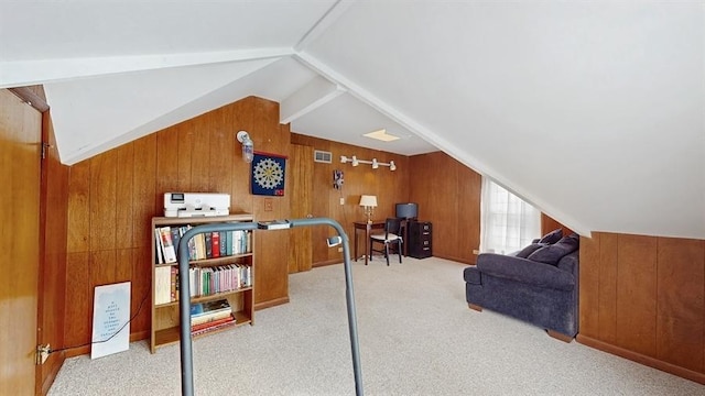 additional living space with light carpet, wooden walls, visible vents, and vaulted ceiling