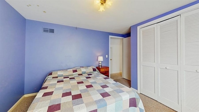 bedroom featuring carpet, a closet, visible vents, and baseboards