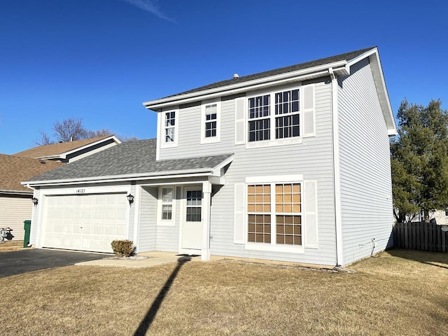 view of front of house featuring roof with shingles, a front yard, fence, a garage, and driveway