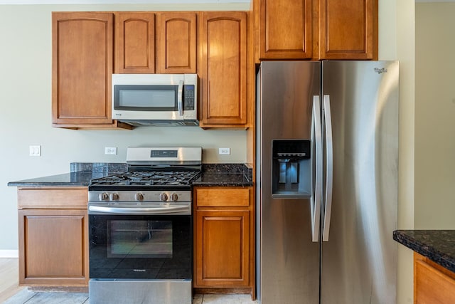 6074 Ironwood Ln, Lisle, IL 60532 - kitchen featuring appliances with stainless steel finishes, dark stone counters, and brown cabinetry