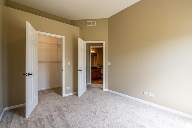 6074 Ironwood Ln, Lisle, IL 60532 - unfurnished bedroom featuring light colored carpet, a spacious closet, a closet, and baseboards