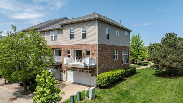 6074 Ironwood Ln, Lisle, IL 60532 - rear view of property featuring brick siding, a yard, a garage, driveway, and a balcony