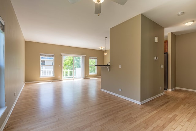 6074 Ironwood Ln, Lisle, IL 60532 - empty room with light wood-style floors, ceiling fan, and baseboards