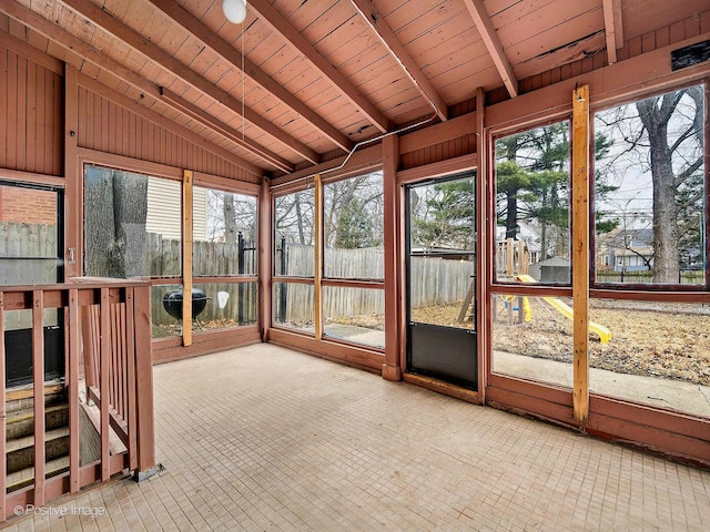 unfurnished sunroom with lofted ceiling with beams and wooden ceiling