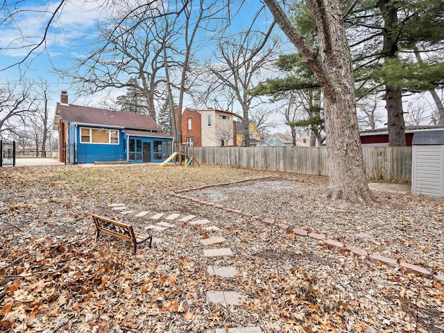 view of yard featuring a fenced backyard and an outdoor structure