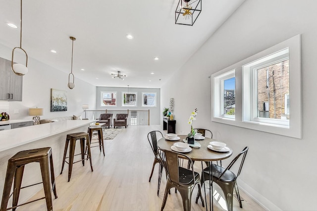 dining space with plenty of natural light and light hardwood / wood-style floors