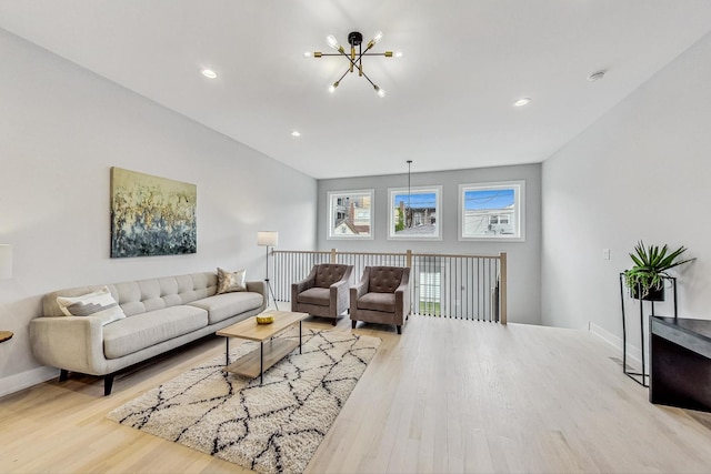 living room with an inviting chandelier and light hardwood / wood-style floors